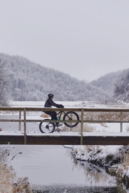 Fat biker doing a wheelie on a bridge at Sidie Hollow County Park